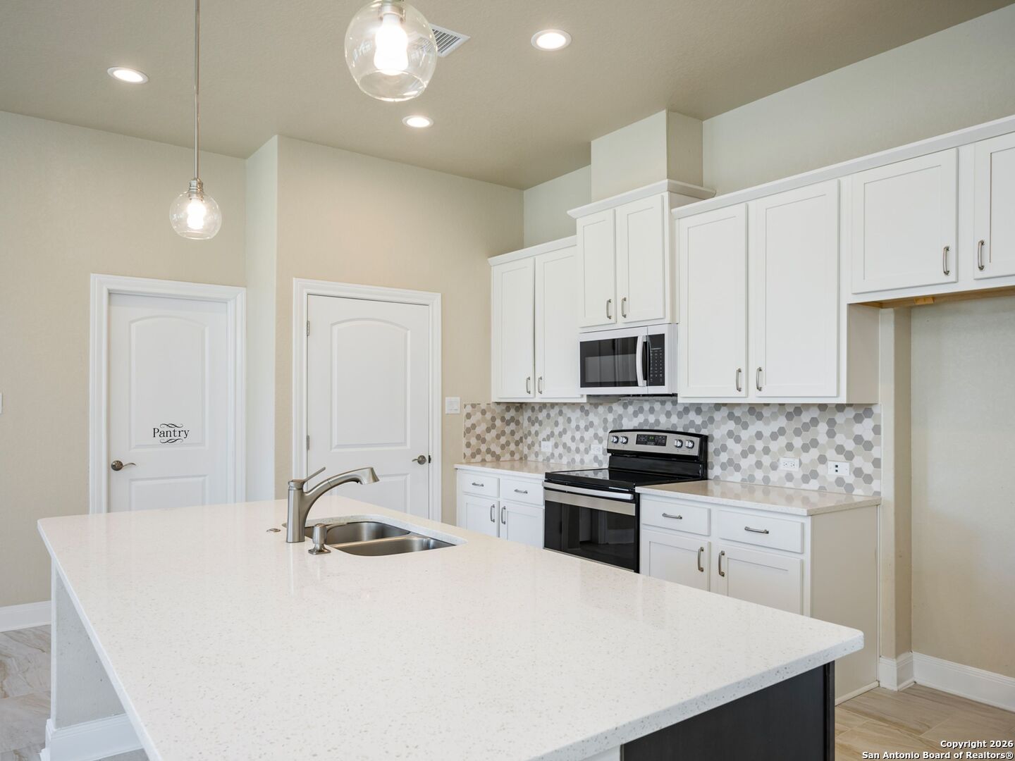 14681 Main Street Lytle, TX 78052 - Photo 10 of 33 a kitchen with stainless steel appliances a stove sink microwave and cabinets