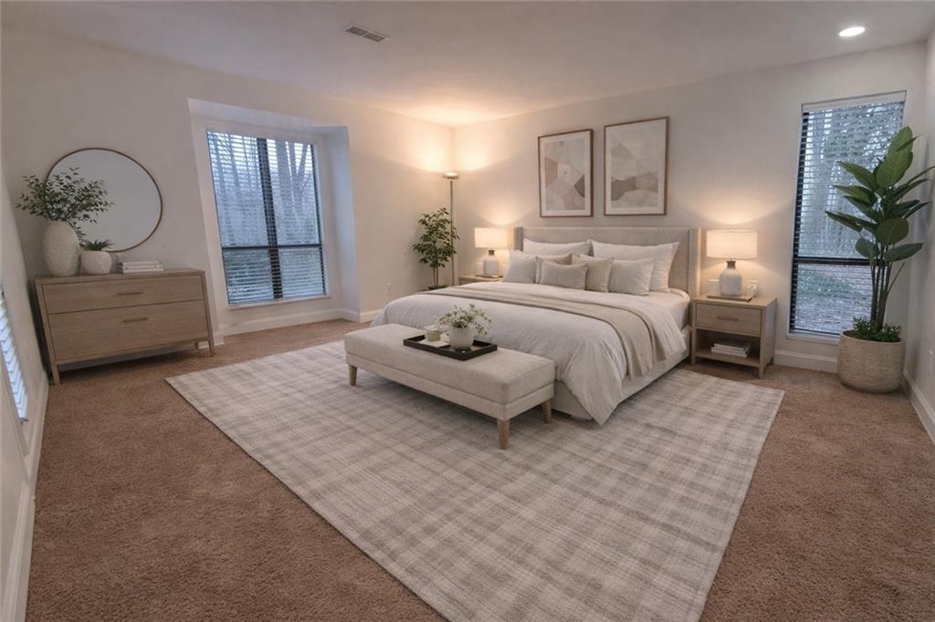 514 Tuxworth Circle Decatur, GA 30033 - Photo 19 of 34 a spacious bedroom with a bed a couch and paintings on the wall