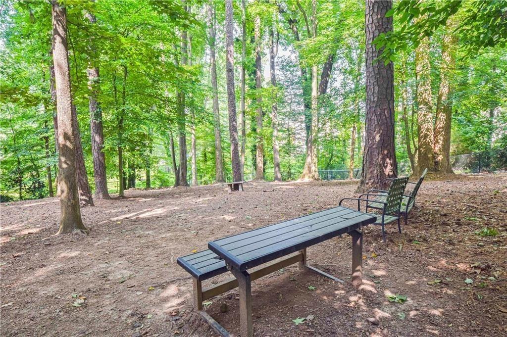 514 Tuxworth Circle Decatur, GA 30033 - Photo 33 of 34 a wooden bench sitting in the middle of a forest