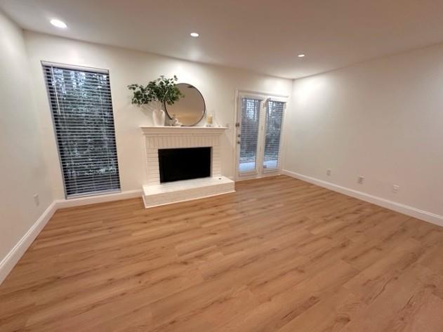 514 Tuxworth Circle Decatur, GA 30033 - Photo 9 of 34 an empty room with wooden floor fireplace and windows