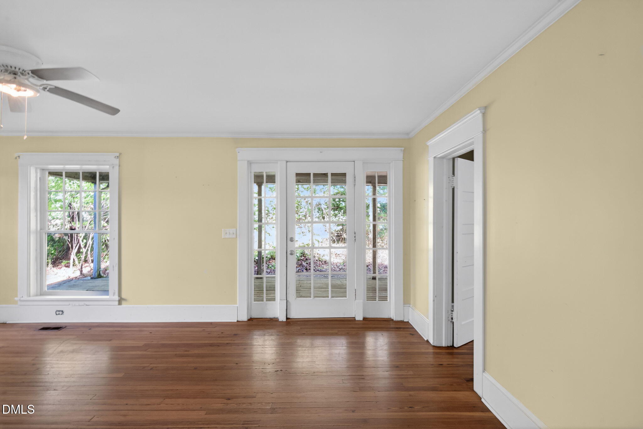 1714 Terry Road Durham, NC 27712 - Photo 5 of 39 a view of an empty room with wooden floor and a window