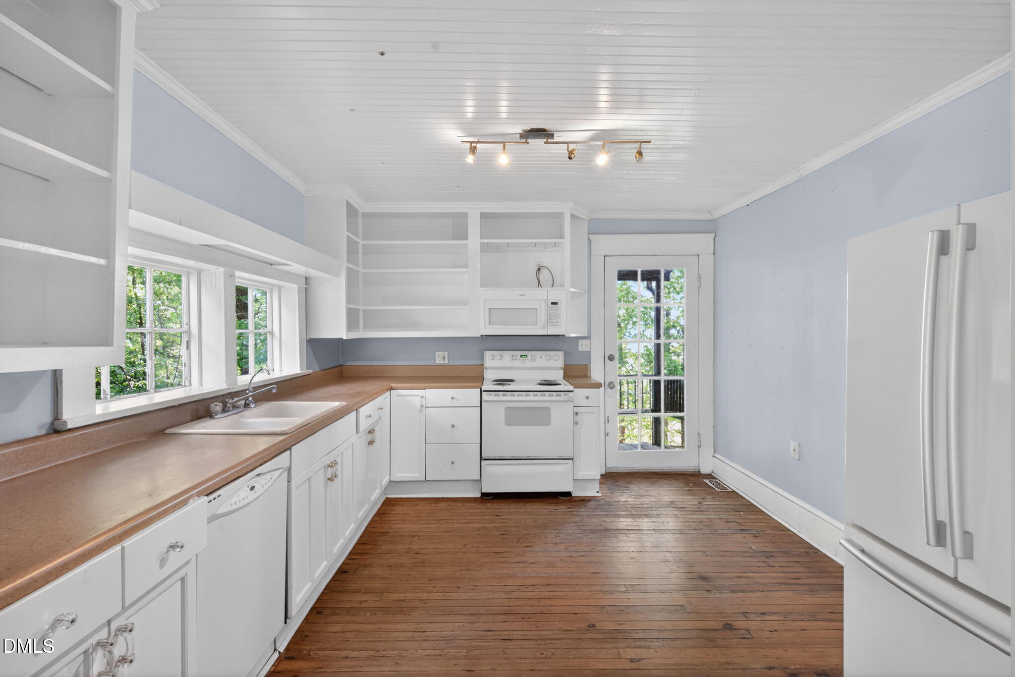 1714 Terry Road Durham, NC 27712 - Photo 7 of 39 a large kitchen with a lot of counter space and wooden floor