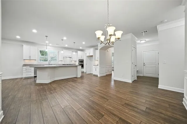 a view of an empty room with a fireplace and a window