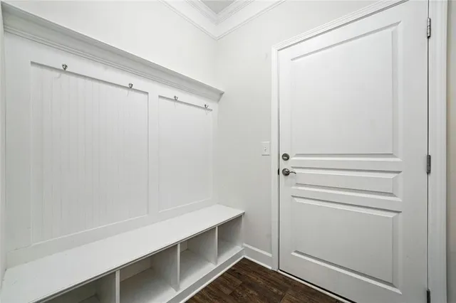a view of an empty room with wooden floor fireplace and a window