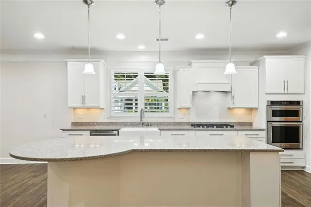 a view of a room with wooden floor and ceiling fan