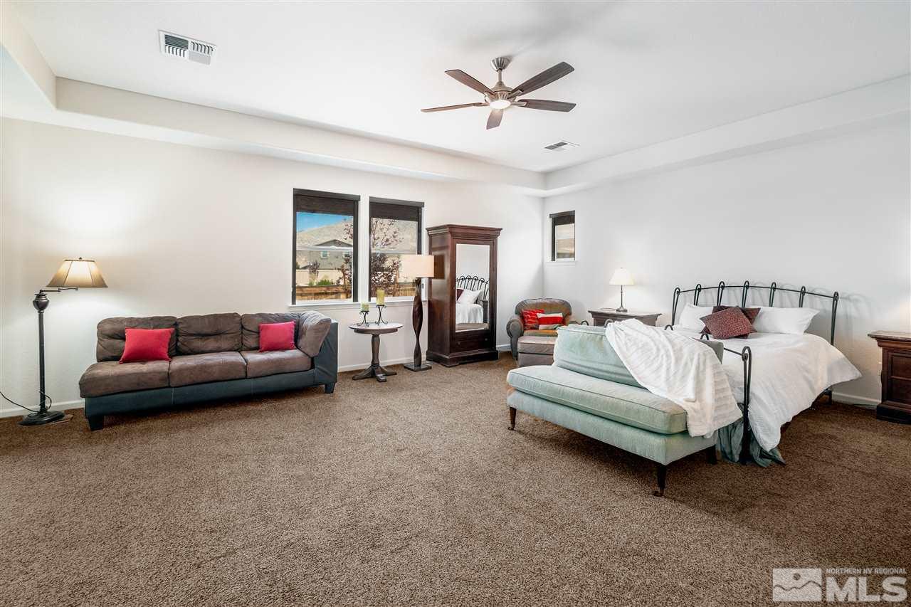 9715 Cardigan Bay Lane Reno, NV 89521 - Photo 14 of 31 a bedroom with bed couch and window