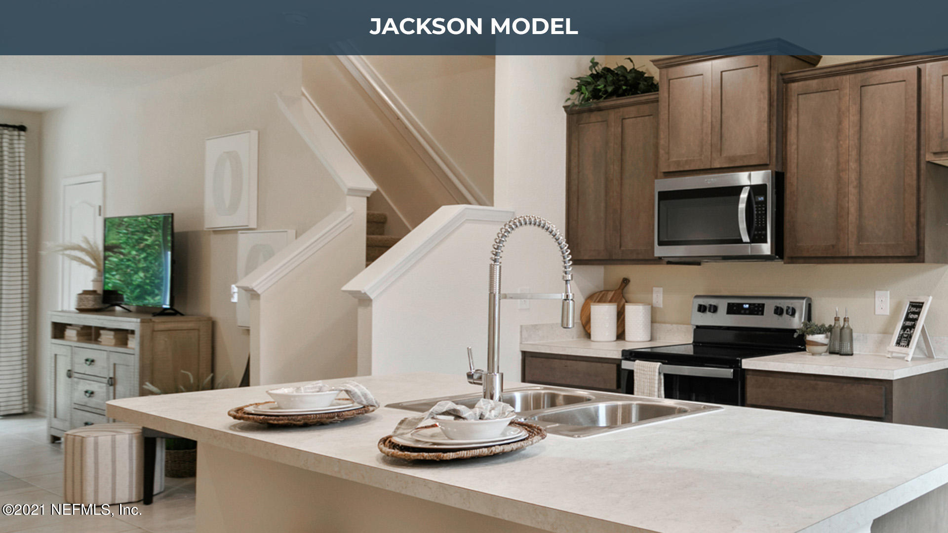 575 Oakleaf Plantation Parkway, Unit 208 Orange Park, FL 32065 - Photo 1 of 22 a kitchen with stainless steel appliances kitchen island granite countertop a sink dishwasher and microwave with wooden floor