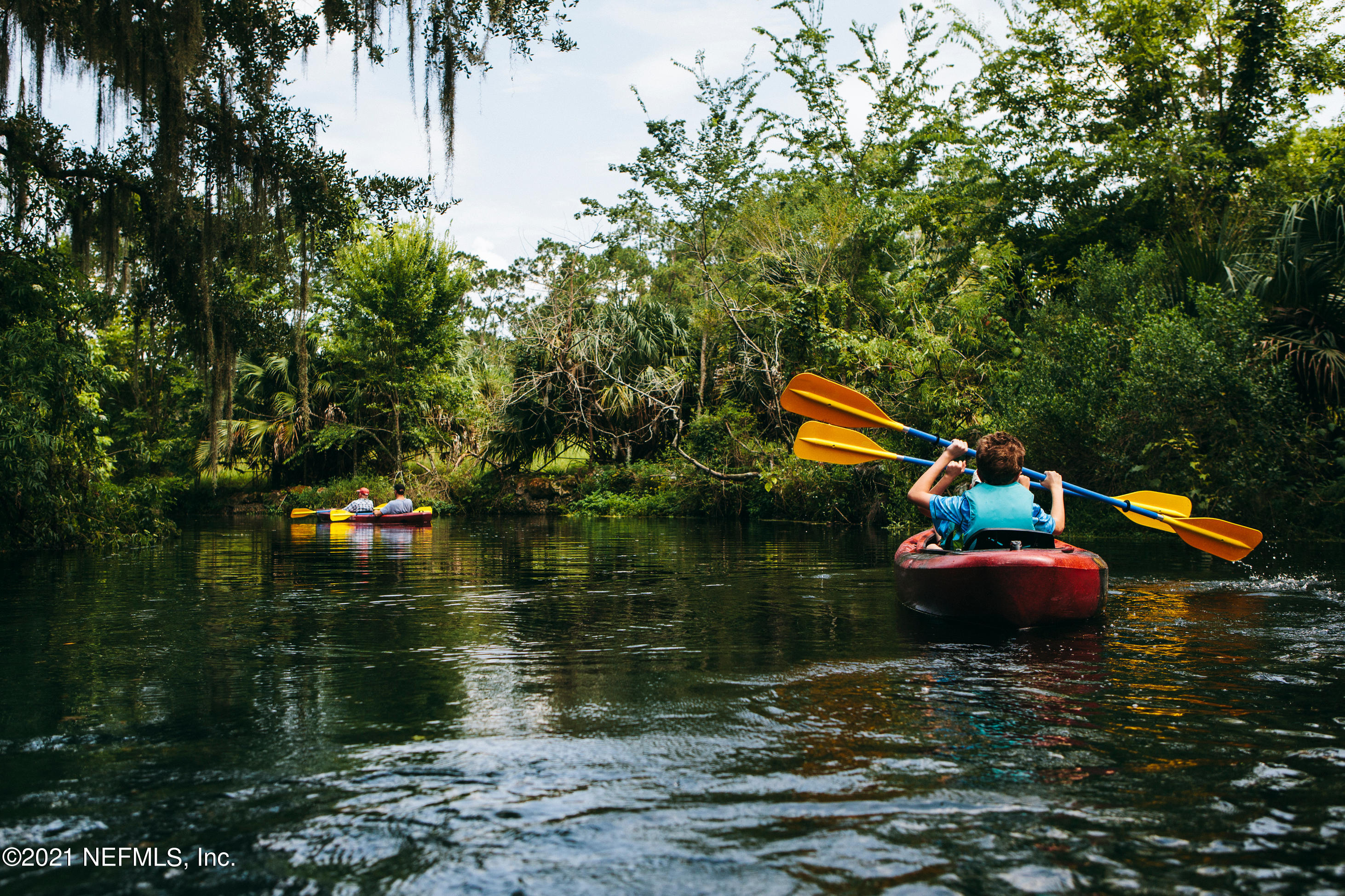 575 Oakleaf Plantation Parkway, Unit 208 Orange Park, FL 32065 - Photo 22 of 22 a backyard of a house with lots of green space and fountain