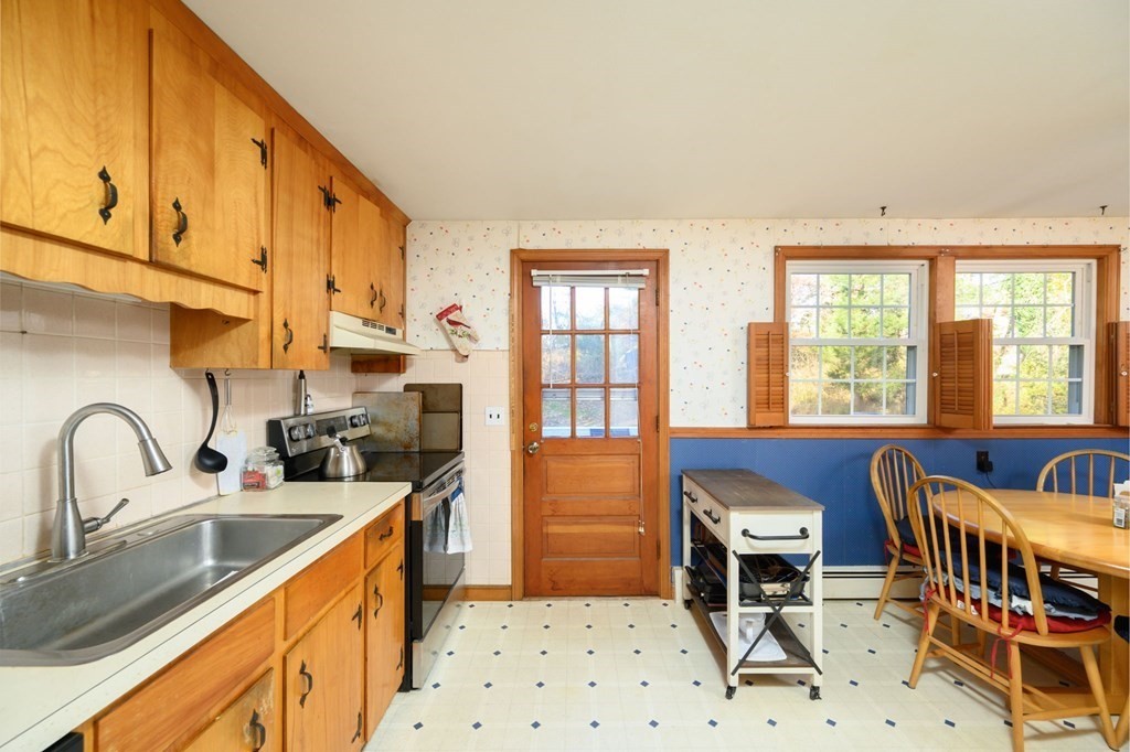 1 Pine Grove Road Hingham, MA 02043 - Photo 12 of 22 a kitchen with stainless steel appliances a sink a stove a refrigerator cabinets and furniture