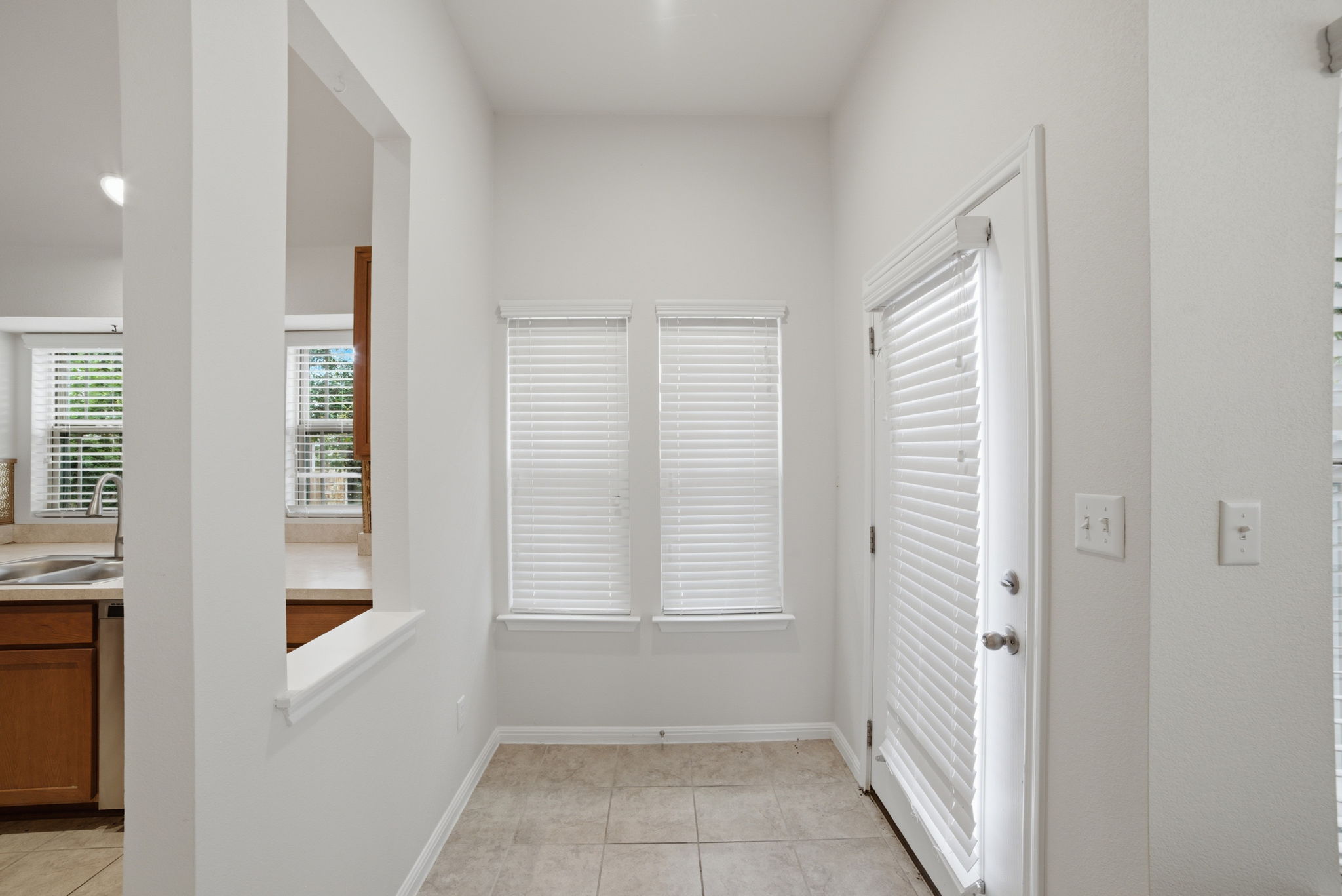 514 Nautical Loop Kyle, TX 78640 - Photo 4 of 24 A well-lit entry with tiled flooring connects to the kitchen, offering both utility and welcoming appeal.