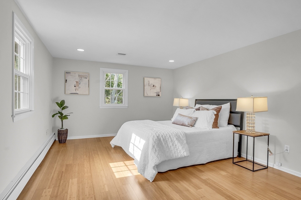 36 Flint Road Acton, MA 01720 - Photo 21 of 37 a bedroom with a bed and wooden floor