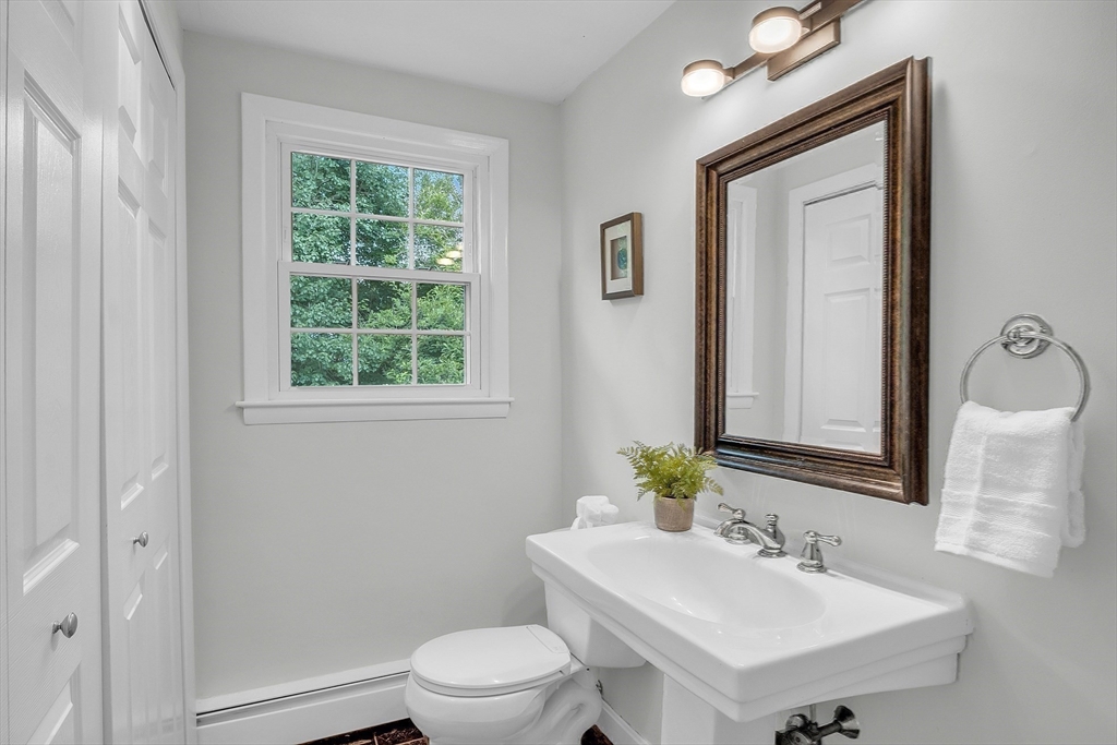 36 Flint Road Acton, MA 01720 - Photo 29 of 37 a bathroom with a toilet a sink a mirror and a window