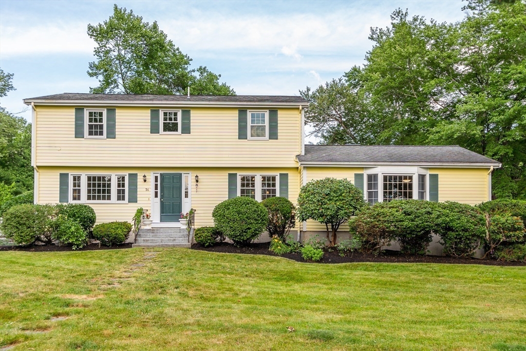 36 Flint Road Acton, MA 01720 - Photo 3 of 37 a front view of a house with a yard and potted plants