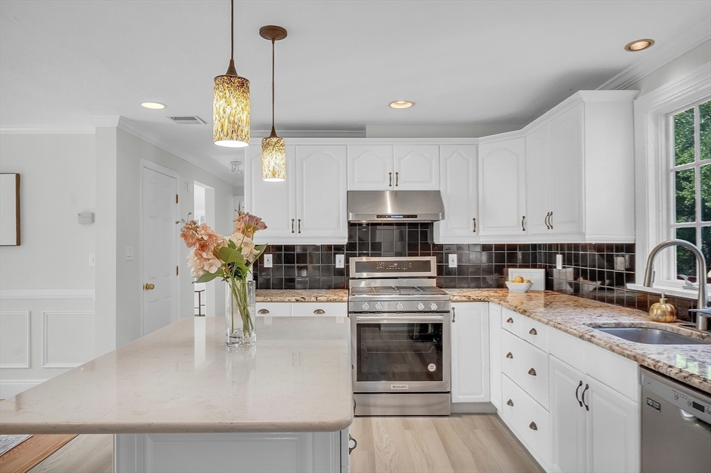 36 Flint Road Acton, MA 01720 - Photo 5 of 37 a kitchen with stainless steel appliances kitchen island granite countertop a stove a sink and a white cabinets