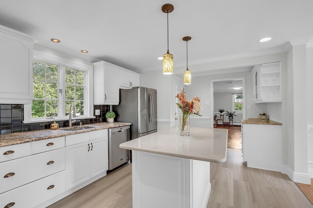 36 Flint Road Acton, MA 01720 - Photo 9 of 37 a kitchen with stainless steel appliances kitchen island a refrigerator sink and wooden floor