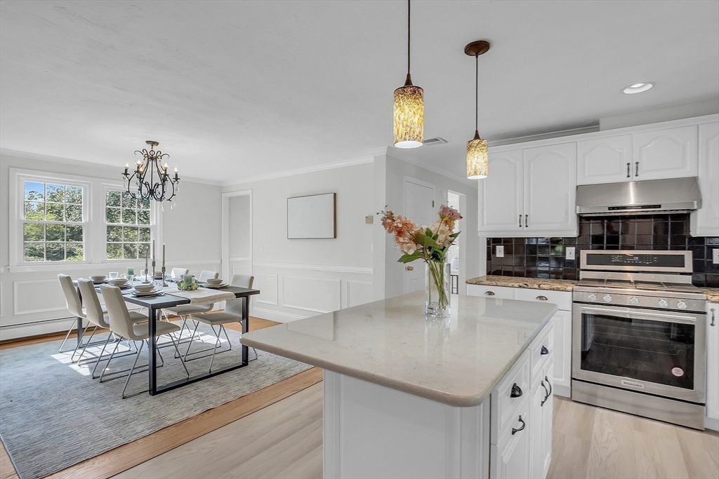 36 Flint Road Acton, MA 01720 - Photo 10 of 37 a kitchen with stainless steel appliances granite countertop a stove a kitchen island a dining table and chairs
