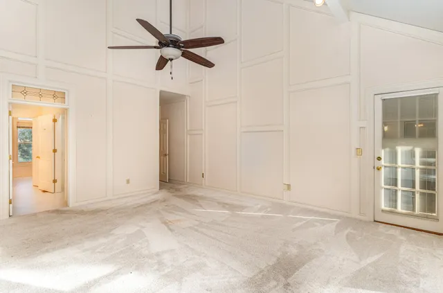 an empty room with closet and windows