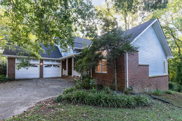 a house that has a tree in front of the house