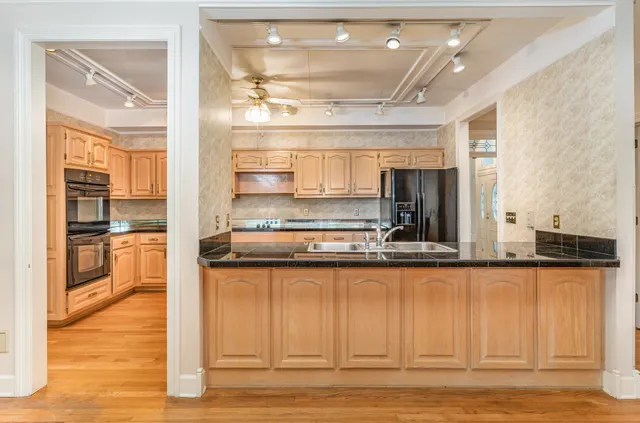 a kitchen with stainless steel appliances granite countertop a sink and cabinets