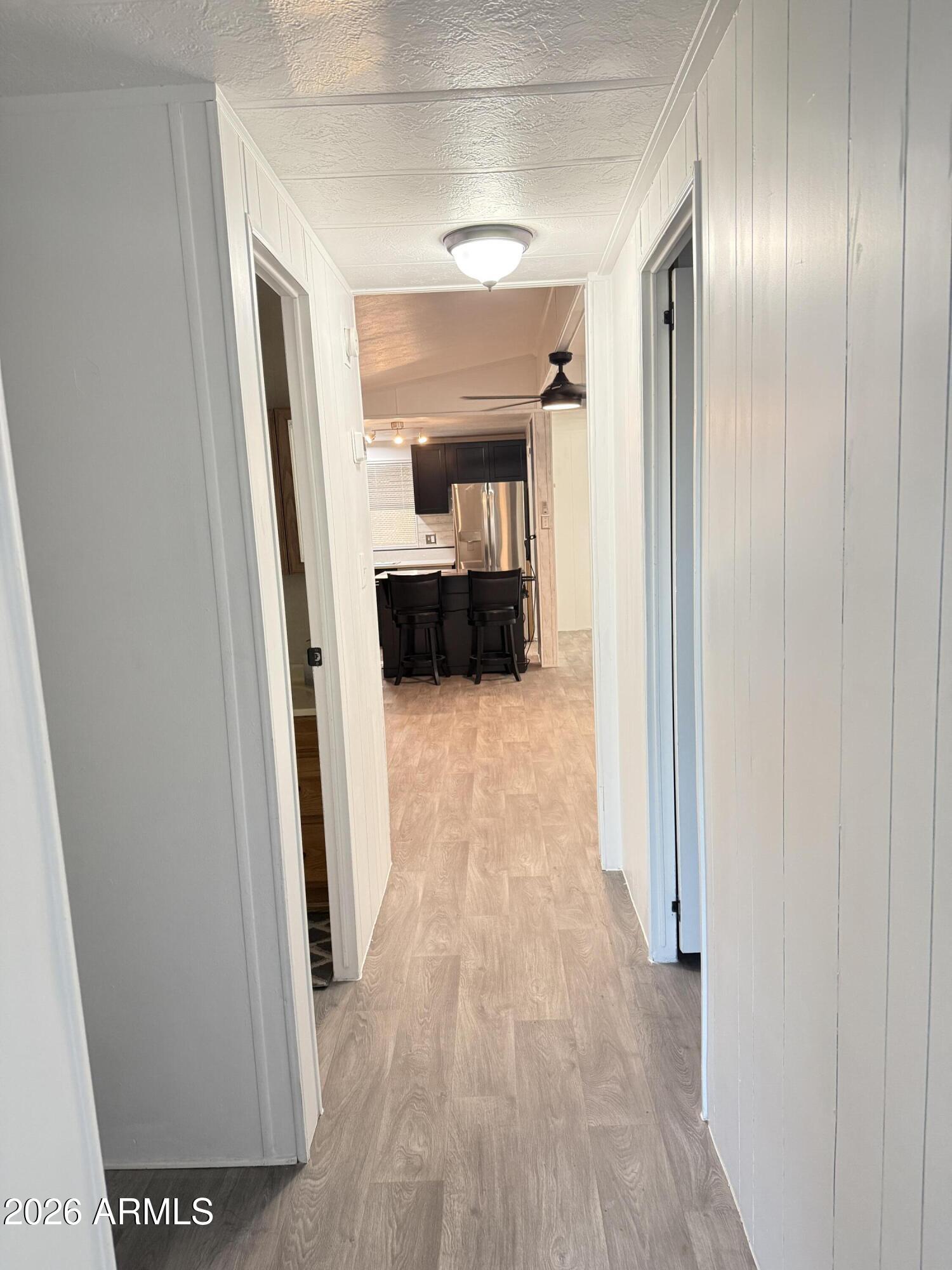 535 South Alma School Road, Unit 113 Mesa, AZ 85210 - Photo 20 of 41 a view of a hallway view with wooden floor and staircase