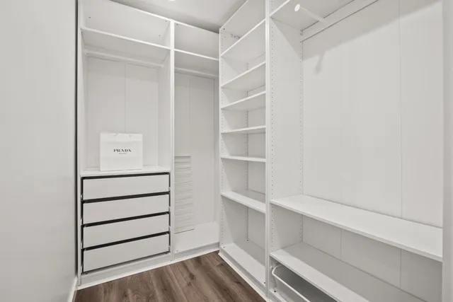a view of walk in closet with empty racks