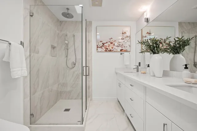 a bathroom with a shower sink and mirror
