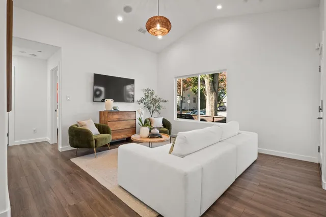 a living room with furniture fireplace and a window