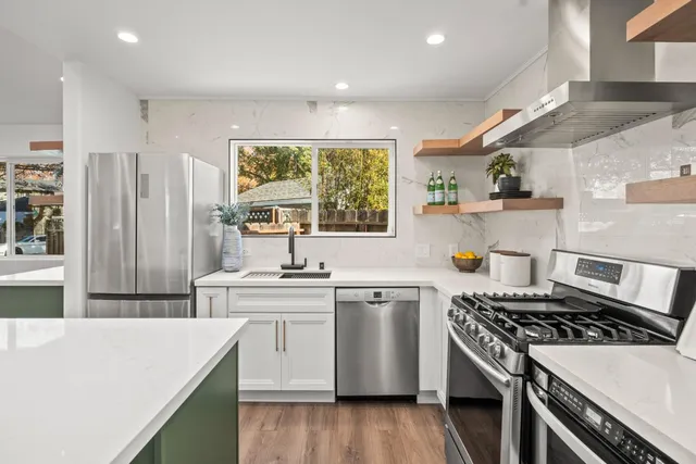 a kitchen with a stove a sink and a refrigerator