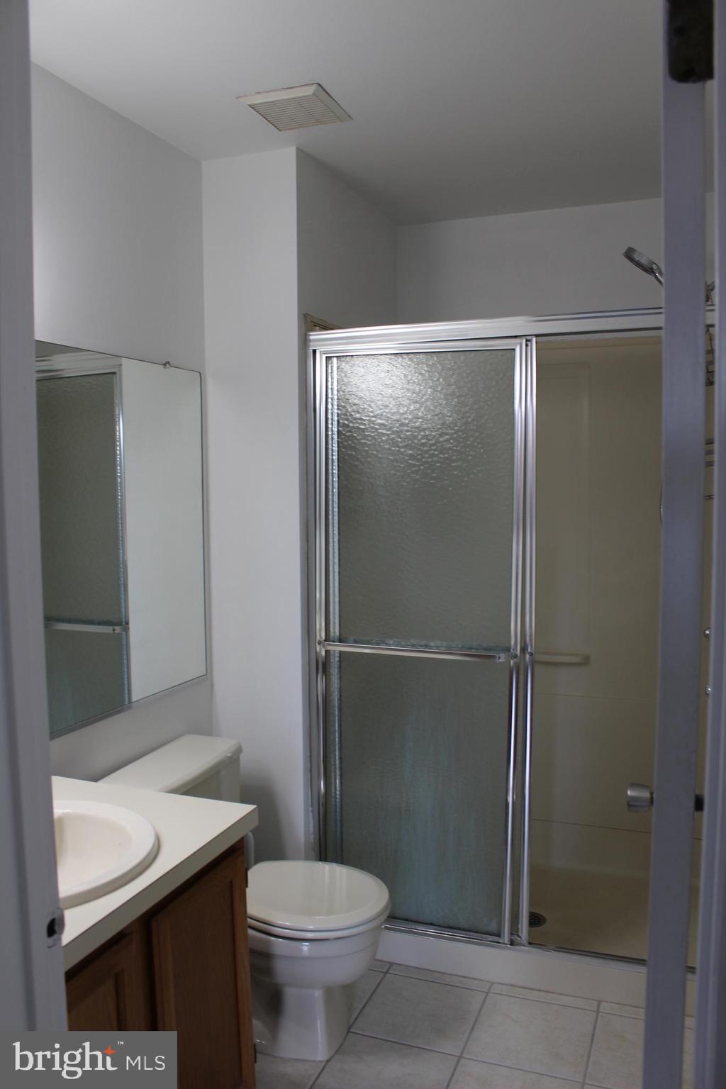 2614 C Auburn Court Mount Laurel, NJ 08054 - Photo 20 of 26 a bathroom with a sink a toilet and shower