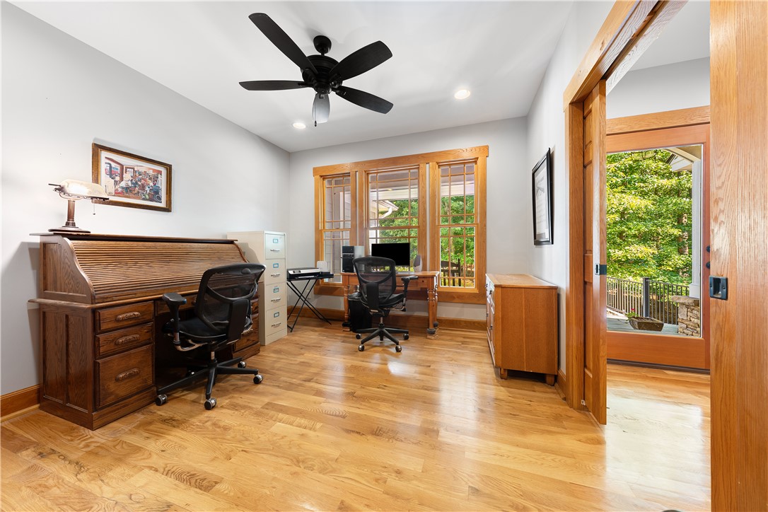 285 Bertha Allen Road Westminster, SC 29693 - Photo 8 of 50 Natural light streams into this versatile office space, featuring rich hardwood floors and direct outdoor access.