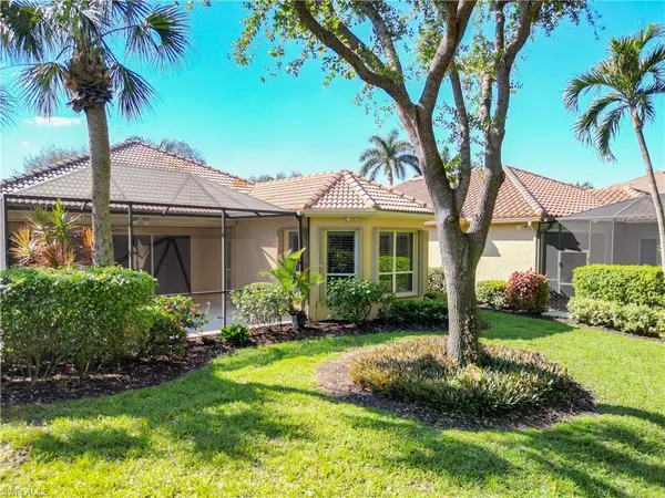 a front view of a house with a garden and yard