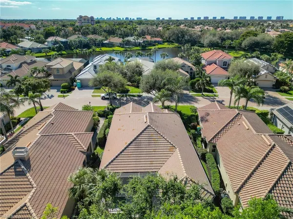 an aerial view of residential houses with outdoor space and pool