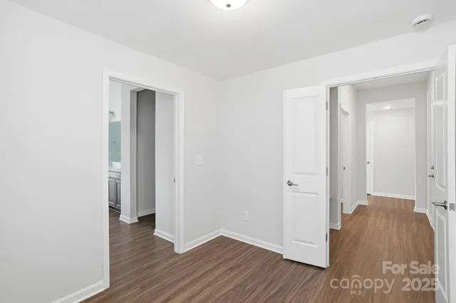 a view of hallway with wooden floor