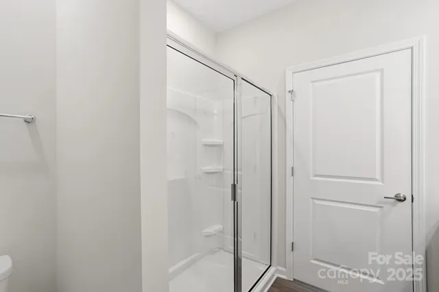 a bathroom with a glass shower door