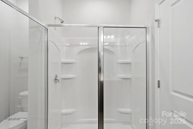 a bathroom with a glass shower door
