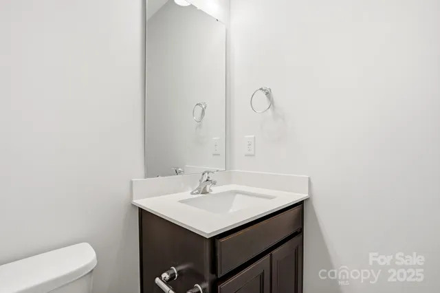 a bathroom with a sink toilet and vanity