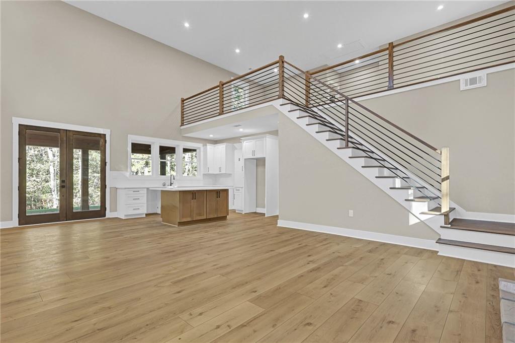 507 North Ridge Road Barnesville, GA 30204 - Photo 3 of 18 a view of an empty room with wooden floor and stairs