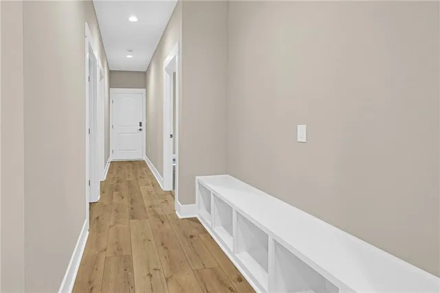 a view of a hallway with wooden floor
