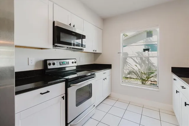 a kitchen with granite countertop a sink and a vanity