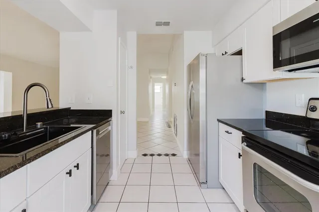 a spacious bedroom with a bed and a window