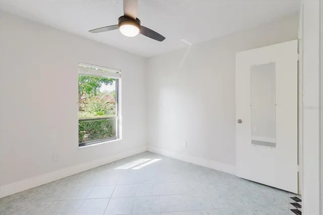 a bedroom with a bed and a lamp on dresser