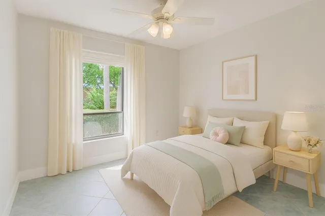 an empty room with a fireplace and large window