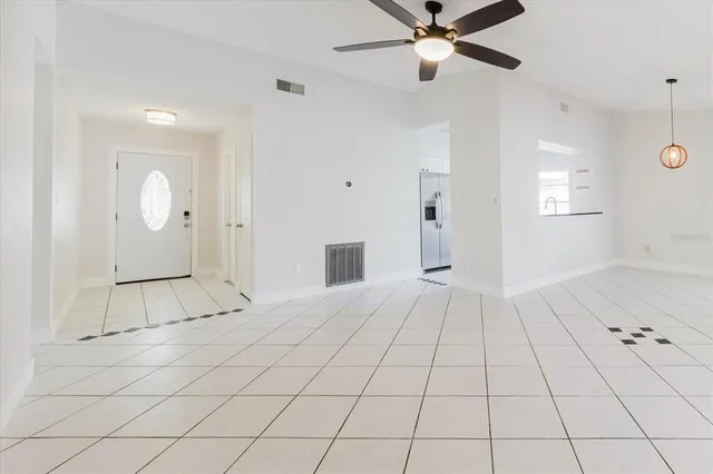 a living room with furniture a flat screen tv and a potted plant