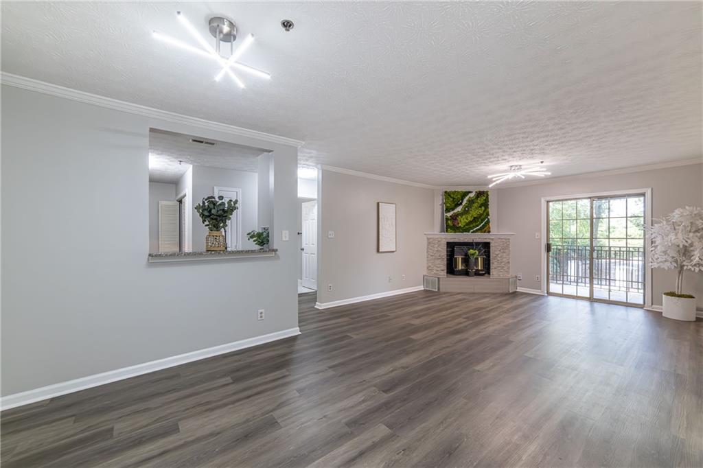 970 Sidney Marcus Boulevard Northeast, Unit 1204 Atlanta, GA 30324 - Photo 1 of 60 a view of an empty room with wooden floor and a window