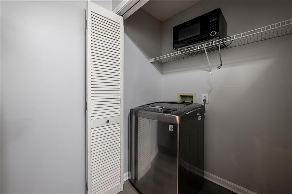 970 Sidney Marcus Boulevard Northeast, Unit 1204 Atlanta, GA 30324 - Photo 17 of 60 a close view of storage and utility room with washer and dryer
