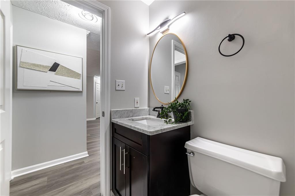 970 Sidney Marcus Boulevard Northeast, Unit 1204 Atlanta, GA 30324 - Photo 23 of 60 a bathroom with a toilet and a mirror