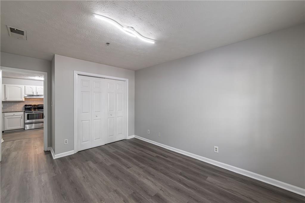 970 Sidney Marcus Boulevard Northeast, Unit 1204 Atlanta, GA 30324 - Photo 25 of 60 a view of a room with wooden floor