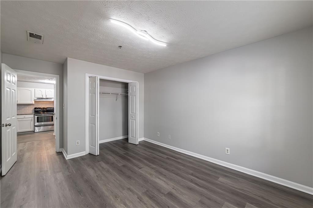970 Sidney Marcus Boulevard Northeast, Unit 1204 Atlanta, GA 30324 - Photo 26 of 60 wooden floor in an empty room with a window
