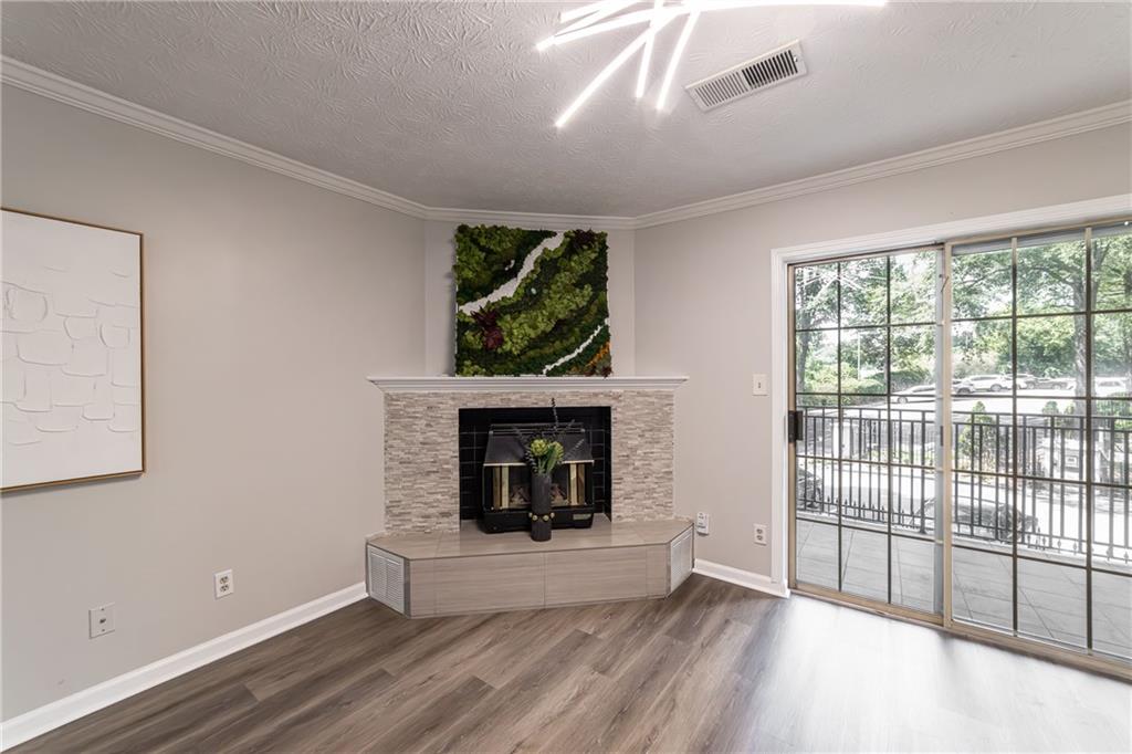 970 Sidney Marcus Boulevard Northeast, Unit 1204 Atlanta, GA 30324 - Photo 29 of 60 wooden floor fireplace and windows in an empty room