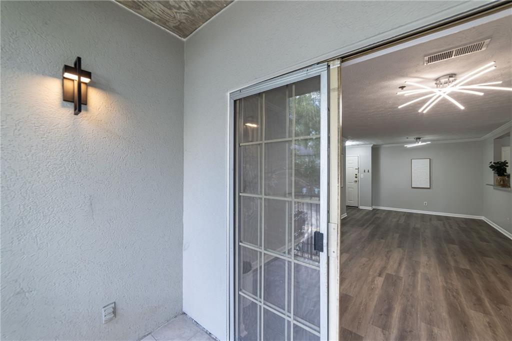 970 Sidney Marcus Boulevard Northeast, Unit 1204 Atlanta, GA 30324 - Photo 33 of 60 a view of empty room with wooden floor and windows